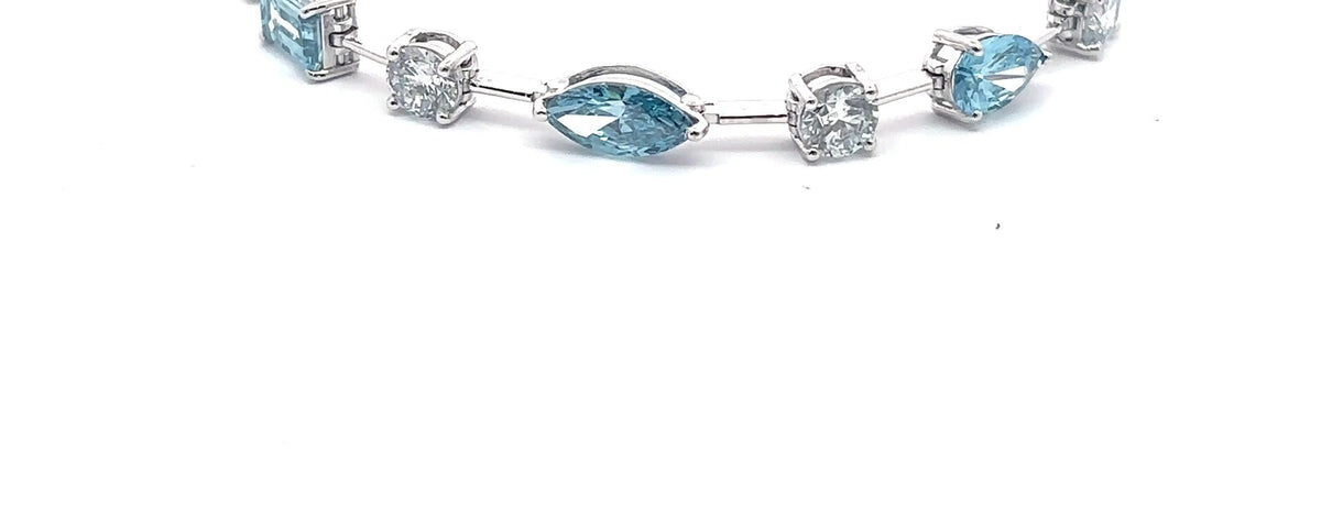 The Capri fancy blue and white diamond tennis bracelet in 14K white gold