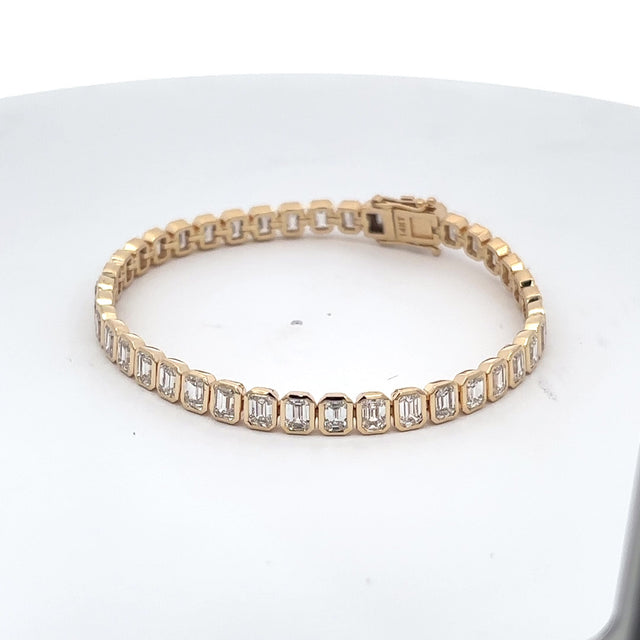 The Capucine bezel-set emerald-cut diamond tennis bracelet in 14K yellow gold